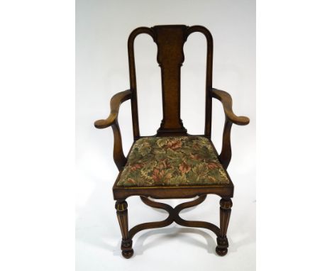 An 18th century style walnut chair with parcel gilt legs, joined by a wavy X frame stretcher, tapestry style drop-in seat