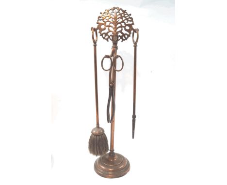 An arts and craft style copper fire compendium, the pierced round finial