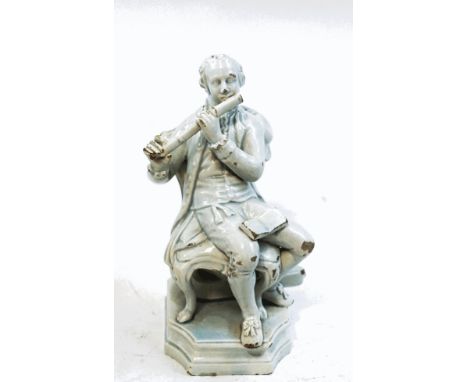 An 18th century pearlware figure of a gentleman sitting on a chair playing the flute, with sheet music on his lap, his violin