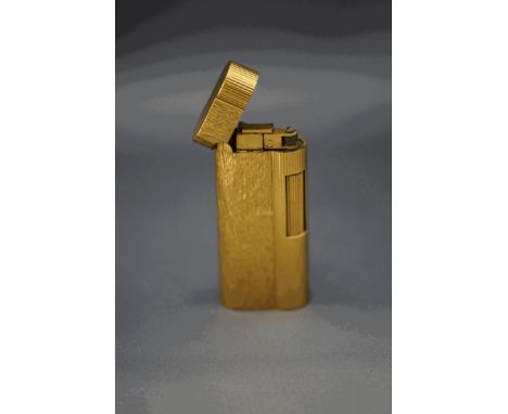A Dunhill gold plated cigarette lighter with two tone textured case
