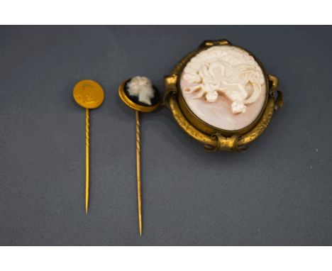  A hardstone cameo stick pin, unmarked; with a Turkish (?) gold coin mounted as a stick pin; and a Conch shell cameo brooch t