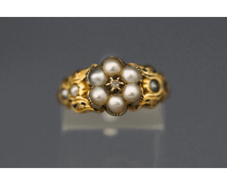 A Victorian mourning ring, the split pearl cluster around a silver collet set rose cut diamond, traces of enamel, finger size