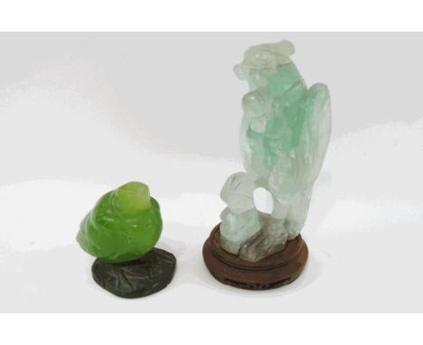 A Chinese carved jade figure of a bird, upon a turned wooden stand, 18cm high, together with another carving of a bird, 9.5cm