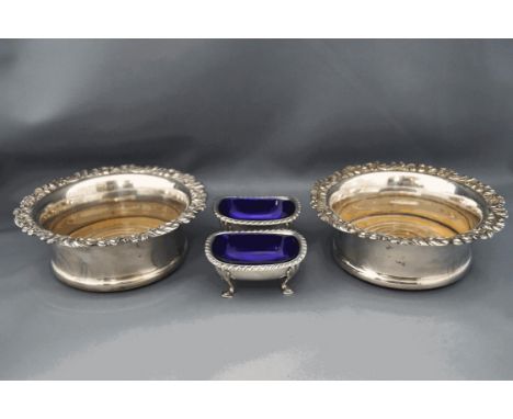 A pair of Sheffield plate wine coasters, with turned wooden base, 17.5 cm diameter, and a pair of plated salts with blue glas