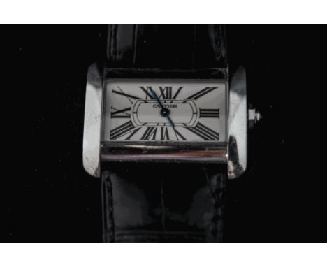 Cartier, a lady's small tank Divan steel wristwatch, on a strap, facetted stone set crown, numbered 196224CE and 2599, with b