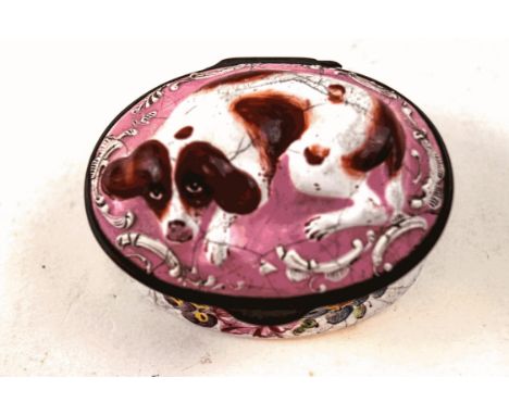 A 19th century enamel snuff box, the top with a recumbent spaniel on a pink ground, and flower sprigs to the base, 6.5cm wide