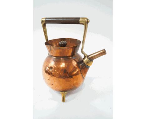 A Christopher Dresser style brass and copper teapot on three splayed legs, 25cm high