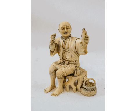 An early 20th century Japanese carved ivory figure of a fisherman, seated upon tree trunk base holding aloft a fish, signatur