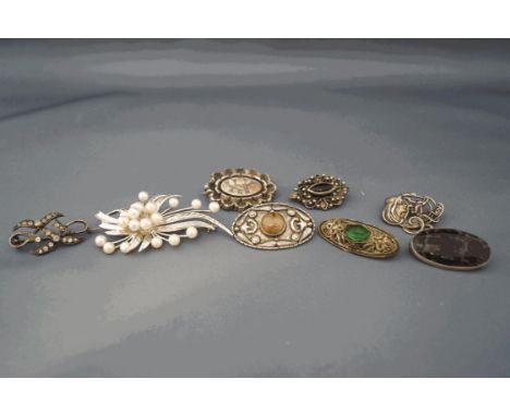 A collection of eight brooches, including a Blue John set brooch; a cultured pearl set spray brooch; an Art Nouveau style bro
