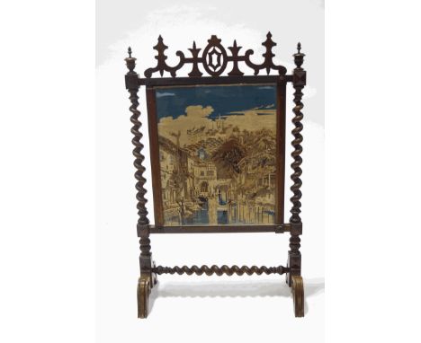 A Victorian rosewood firescreen with tapestry panel of a Continental town and river scene, 105cm high x 65cm wide