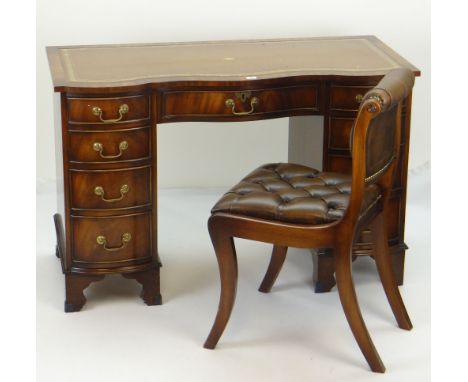 NEAT REPRODUCTION MAHOGANY SERPENTINE DESK with tooled leather writing surface and pair of flanking banks of four drawers, ce