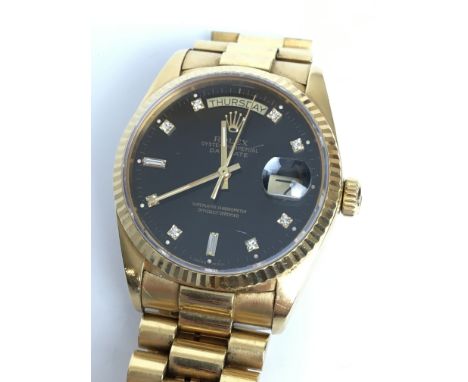 A GENTLEMANS 18K GOLD & DIAMOND ROLEX OYSTER PERPETUAL DAYDATE AUTOMATIC WRIST WATCH 
 •Black dial with gold & diamond set nu