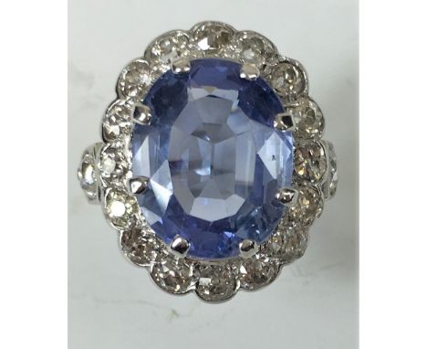 PLATINUM DIAMOND AND SAPPHIRE CLUSTER RING
An antique white metal (tests as Platinum) Diamond and pale blue Sapphire cluster 