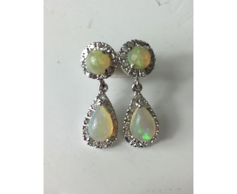 OPAL AND DIAMOND EARRINGS
A pair of 18ct white gold Opal and Diamond earrings with teardrop shaped Opals suspended from small