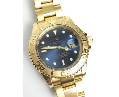 A GENTLEMANS 18K GOLD ROLEX OYSTER PERPETUAL DATE YACHT MASTER WRIST WATCH 
 •Blue slate dial with gold numerical dots/ baton