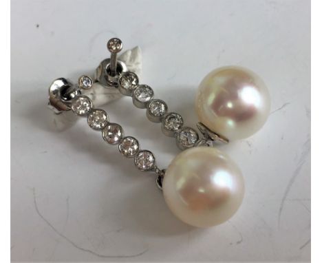 DIAMOND AND PEARL DROP EARRINGS (STUD ENHANCERS)
A pair of Diamond and Pearl drop earrings designed as stud earring enhancers