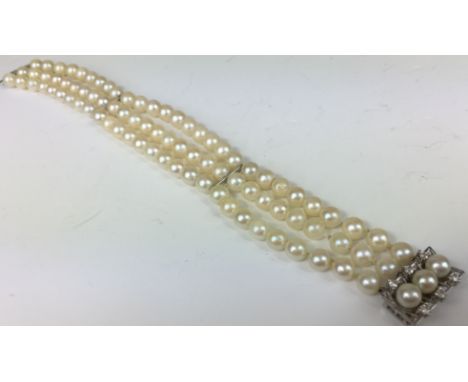 CULTURED PEARL AND DIAMOND BRACELET.
A three row Cultured Pearl bracelet with 14kt white gold fittings and a 14kt white gold 