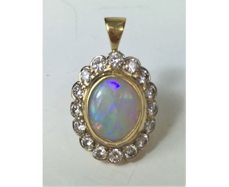 OPAL AND DIAMOND PENDANT.
A yellow metal (tests as 18ct gold) Opal and Diamond pendant comprising central white Opal  surroun