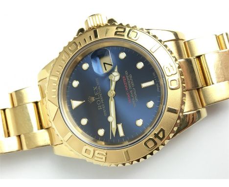 A GENTLEMANS 18K GOLD ROLEX OYSTER PERPETUAL DATE YACHT MASTER WRIST WATCH 
 •Blue slate dial with gold numerical dots/ baton