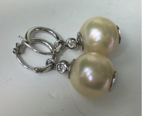 DIAMOND AND PEARL EARRINGS
A pair of 18ct white gold cultured Pearl and Diamond earrings with a large 14mm cultured Pearl and