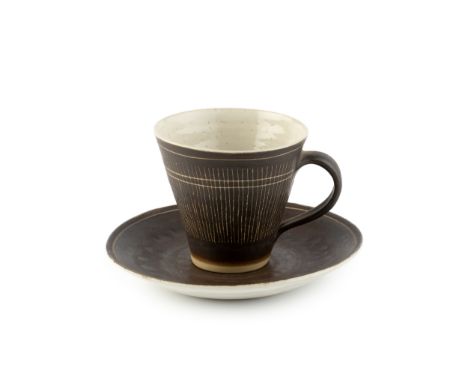 Lucie Rie (1902-1995) Cup and saucermanganese glaze, sgraffito decoration impressed potter's seal cup 7.5cm high, 14cm diamet