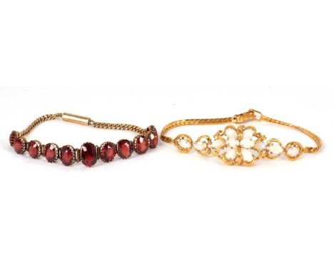 A garnet bracelet, comprised of eleven oval graduated faceted garnets, between approx. 5 - 10mm long, all claw mounted to sho