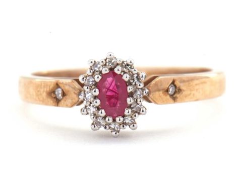 A 9ct ruby and diamond ring, the oval ruby surrounded small single cut diamonds, with a single diamond highlight to each shou