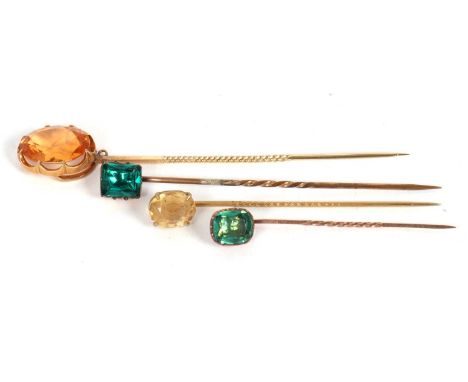 Four stick pins: to include an unmarked oval orange quartz pin, 12mm wide, 4.7g; an unmarked oval citrine pin, 1.2g; an unmar