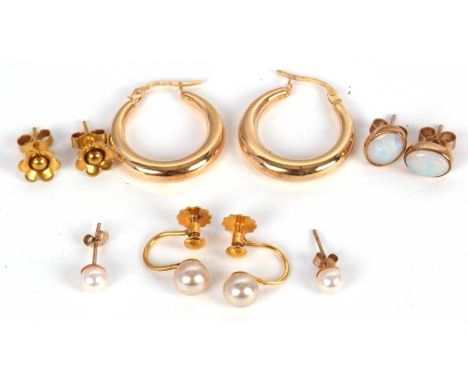A mixed lot of earrings: to include a pair of earhoops stamped 375; a pair of flower eartuds stamped 375; a pair of oval opal