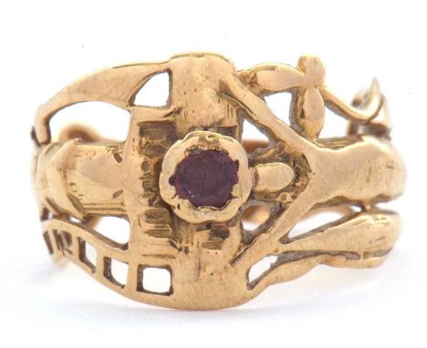 An Art Nouveau style ruby ring, the abrstract undulating design set to centre with a small ruby, with tapering shoulders and 
