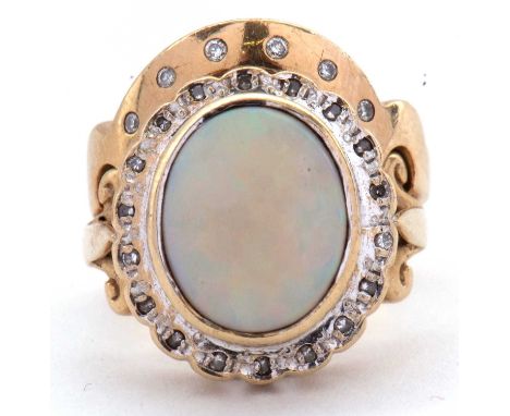 A 9ct opal and diamond ring and a 9ct diamond band, the oval opal cabochon, collet mounted and surrounded by small round diam