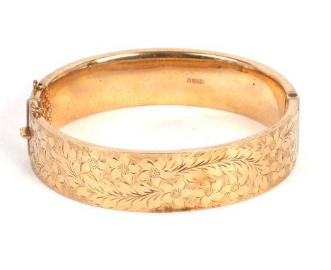 A 9ct gold bangle, with engraved floral decoration to upper half and plain lower half, stamped 375 to both halves and hallmar