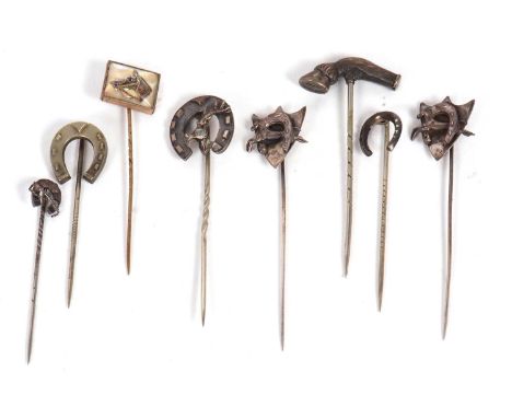Eight sporting stick pins: to include a horse hoof pin, unmarked; a pair of silver shield shape horse shoe and horse pins; a 