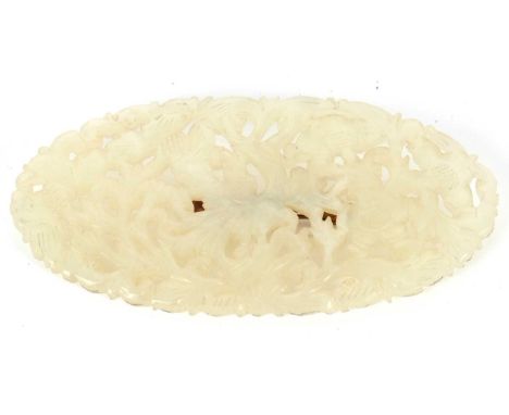 A jade brooch, the oval pierced and carved jade panel with later brooch pin to reverse, 11cm long, 45g