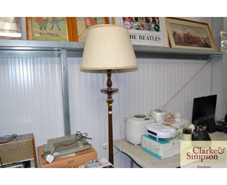 A turned wooden standard lamp and shade 