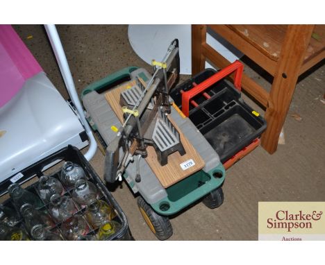 A toolbox, a plastic trug and a mitre saw
