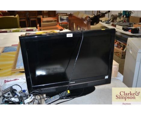 An Hitachi flat screen TV with remote control