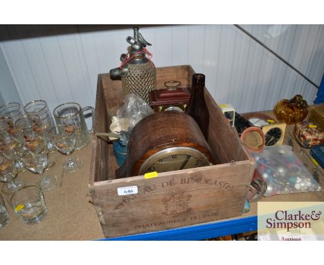 A wooden wine box containing soda syphon, oak two hole mantel clock, oil can etc.