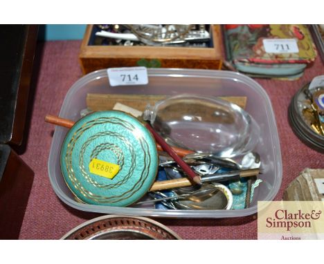 A box containing a compact, various cutlery, bottle stopper etc.