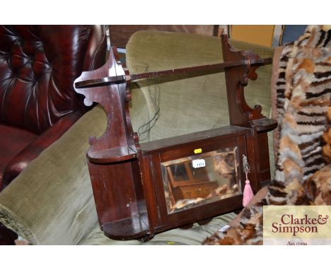A mahogany hanging mirrored shelf cupboard