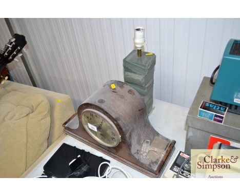 An oak cased three hole mantel clock and a table lamp