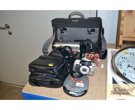 A portable CD player, Pentax camera and Panasonic video camera with accessories