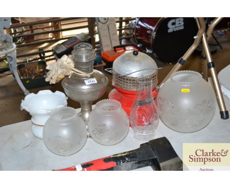 An oil lamp together with three opaque glass shades and a milk glass shade etc