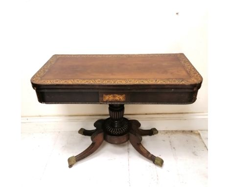 Antique mahogany fold over card table with pedestal base terminating on 4 sabre legs with the original green baize. losses an
