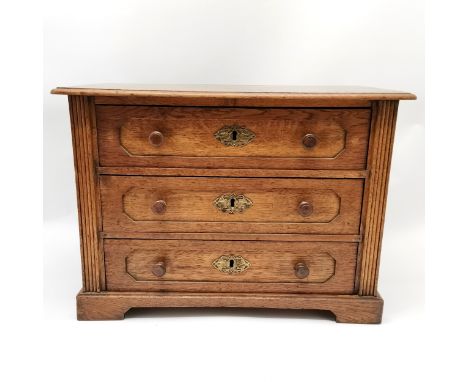 Continental oak 3 drawer cabinet on bracket feet with brass escutcheons and reeded detail - 50cm x 31cm deep x 40cm