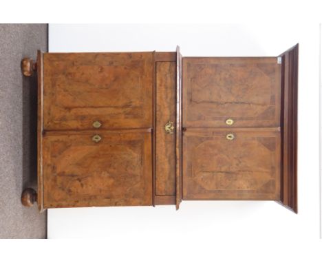 Queen Anne burr walnut cupboard on cupboard, projecting cornice over two doors with geometric banded inlay, enclosing single 