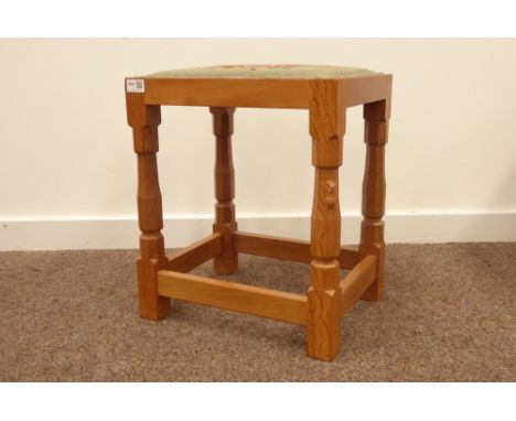 'Mouseman' Yorkshire oak stool by Robert Thompson of Kilburn,with needlework upholstered seat, turned supports united by stre