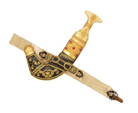 ‡˜AN ARAB DAGGER (JAMBIYA), 20TH CENTURY with curved doubled-edged blade formed with a medial ridge, gold-mounted ivory hilt 