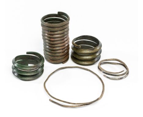 EIGHT SPIRAL ARM RINGS, SILVER AND BRONZE, BALTIC, 9TH TO 12TH CENTURY, AND A SILVER NECK RING two of silver, plain lozenge-s