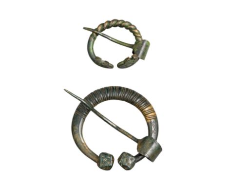 THIRTEEN PENANNULAR BROOCHES, BALTIC, 8TH TO 13TH CENTURY eleven with ribbed or twisted hoops and two with plain hoops, with 